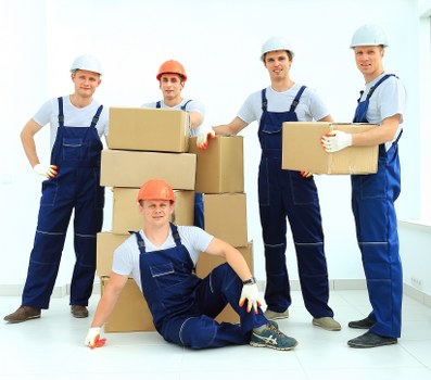 Removal team planning a move in Wimbledon with boxes and furniture