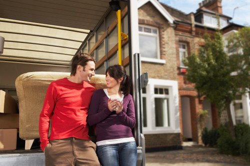Careful loading of unwanted furniture into a collection vehicle in Wimbledon